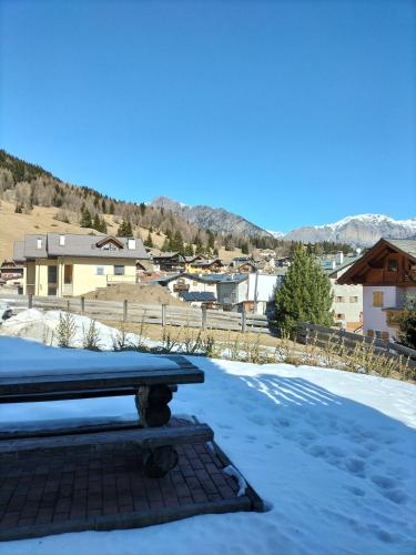 a bench sitting on top of a snow covered yard at Baita Rutic in Oga