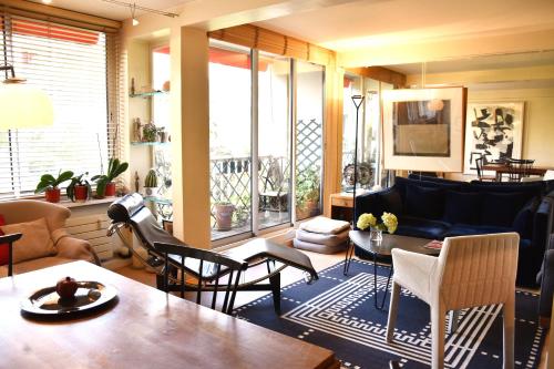 un salon avec un canapé, une table et des chaises dans l'établissement Eiffel Tower - Suffren, à Paris