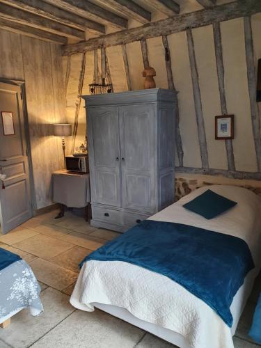 a bedroom with a bed and a cabinet and a sink at L'Escapade in Foulbec
