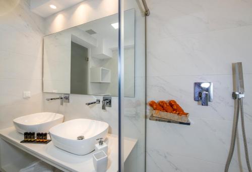 a white bathroom with a sink and a shower at Imperium Luxury Villas-Sauna, Jacuzzi, Heated Pool & Gym-Chania in Kato Galatas