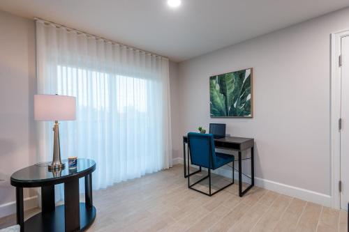 a room with a desk and a blue chair at Wiggins Pass Chalet in Naples