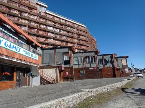 an empty street in front of a large building at Studio au Pied des Pistes avec Vue sur la Station 5 pl in La Mongie