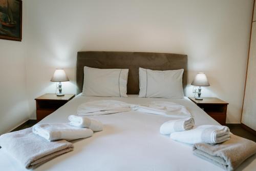 a bedroom with a bed with towels on it at Villa Rena in Sivota