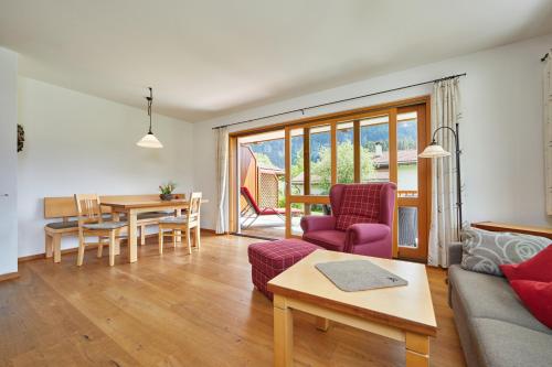 a living room with a couch and a table at Ferienhaus Alpinissimo in Oberammergau