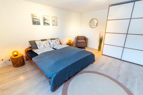 1 dormitorio con 1 cama y 1 silla en Charmantes Apartment mit grossem Garten .Kids4free., en Flims