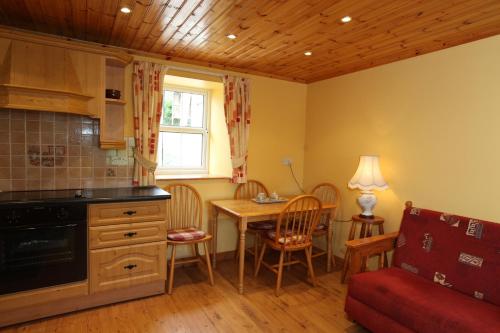 a kitchen and dining room with a table and chairs at John Joe's Self Catering in Blacklion
