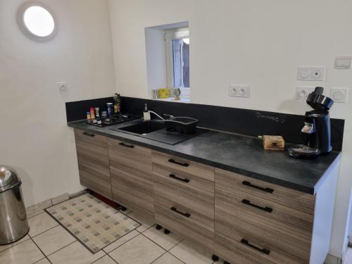 a kitchen with a sink and a counter top at Impasse secrète - Duplex - WIFI in Issoire
