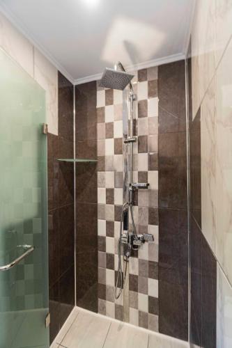 a bathroom with a shower with a glass door at Vila Vista Вила Виста in Sveti Vlas