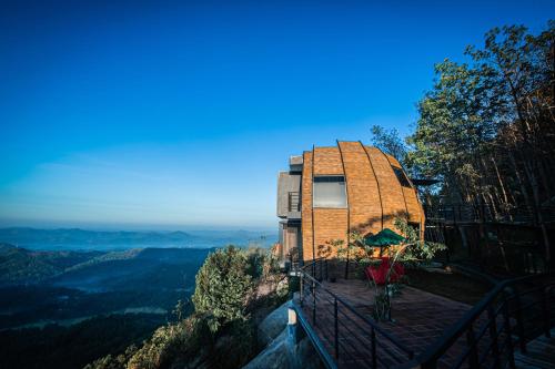 a house on top of a hill with a view at Green Acres Leisure Resort & Spa in Kandy