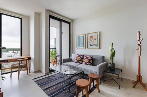 a living room with a couch and a table at San Francisco by Andiani Travel in Cancún