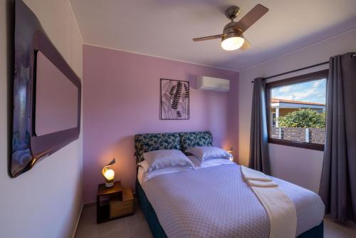 a bedroom with a bed and a window at Desa Green Homes in Ancient Epidavros
