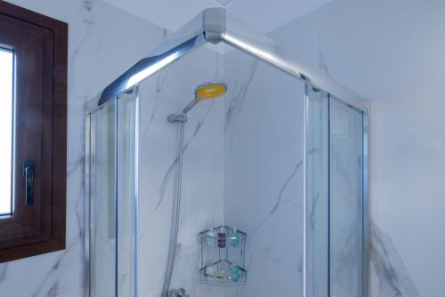 a shower with a light in a bathroom at Desa Green Homes in Ancient Epidavros