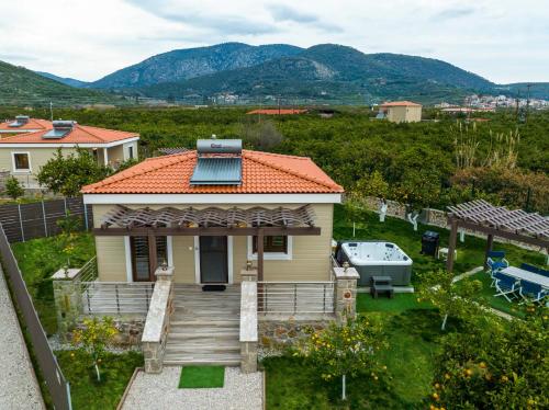a small yellow house with a red roof at Desa Green Homes in Ancient Epidavros