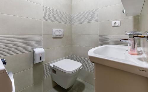a bathroom with a toilet and a sink at Medulinka apartments in Medulin