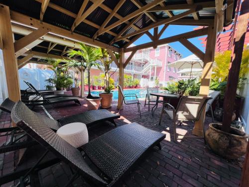 a patio with chairs and tables and a pavilion at The Riverview Hotel - New Smyrna Beach in New Smyrna Beach