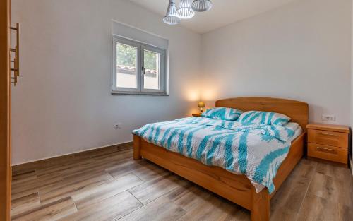 a bedroom with a bed and a window at Medulinka apartments in Medulin