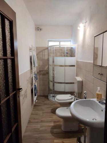 a bathroom with two toilets and a sink at Casale Michelis in Ormea