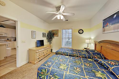 a bedroom with a bed and a ceiling fan at Oasis on the Greens in Myrtle Beach