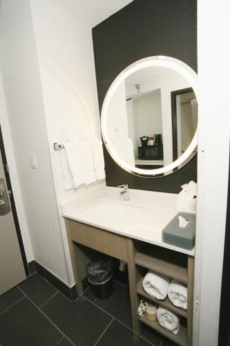 a bathroom with a sink and a mirror at La Quinta by Wyndham Des Moines West Clive in Clive