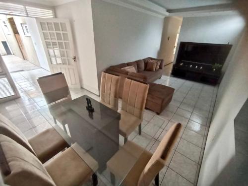 a living room with a table and a couch at Sua casa fora de casa in Fortaleza