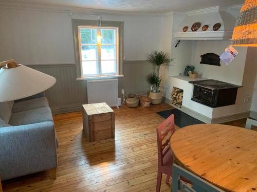 a living room with a blue couch and a table at HomeSweetSweden in Malung