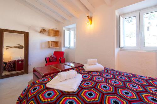 a bedroom with a large bed with towels on it at Hillside 1 Aljezur old town in Aljezur