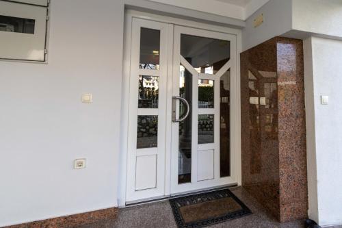 a white door with a sign on it on a building at Apartments Arna in Visoko
