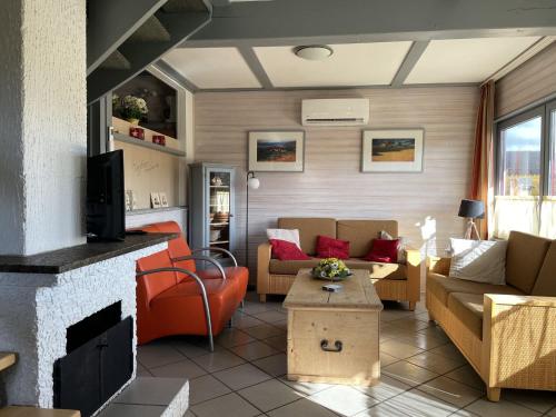 a living room with a couch and a fireplace at Holiday home in Reimboldshausen with balcony in Kemmerode