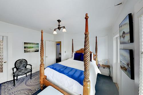 a bedroom with a four poster bed and a chair at Water Lodge in Seattle