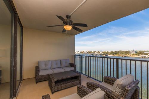 uma varanda com um sofá e cadeiras e uma ventoinha de tecto em Ole River Hideway, Orange Beach, Updated 2 Bedroom Waterfront Condo, Wind Drift em Orange Beach