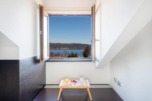 a small table in a room with a window at SIRIOHotel in Dormelletto