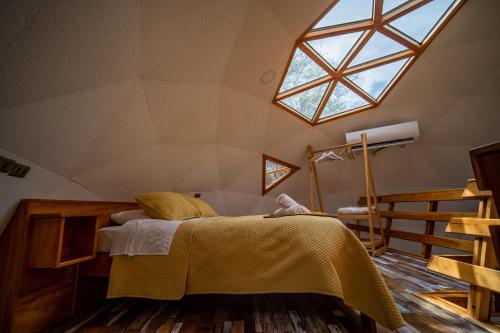 a bedroom with a bed with a large window at Tantakuy Eco Experience Hotel in La Huaica