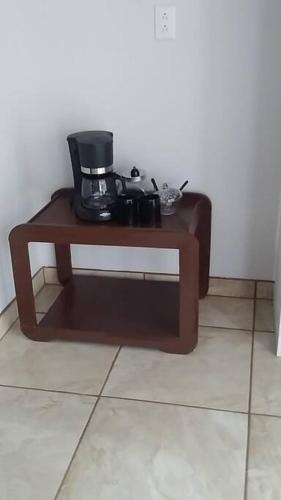 a table with a coffee maker on top of it at Hospedaje Rio Celeste Katira, Habitación privada in San Rafael