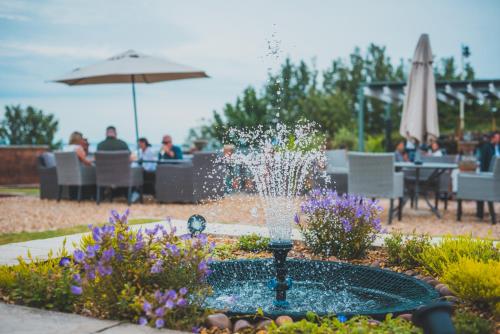a fountain filled with water and flowers on top of a table at Holm House Hotel in Cardiff