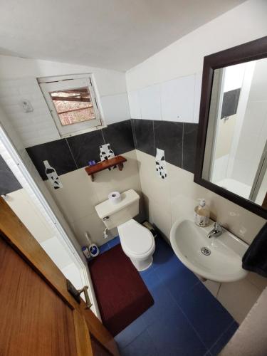 a small bathroom with a toilet and a sink at Refugio en el Bosque in Medellín