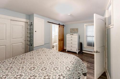a bedroom with a bed and a dresser and a window at Old Orchard Cottage in Old Orchard Beach