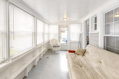 a living room with a couch and some windows at Old Orchard Cottage in Old Orchard Beach