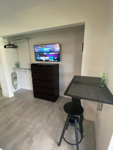 a room with a table and a tv on a wall at LYZ Miami in Miami