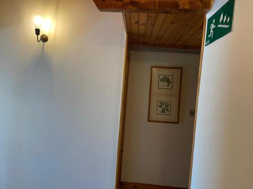 a hallway with a green street sign on a wall at La Casita de la Sierra Cercedilla in Cercedilla