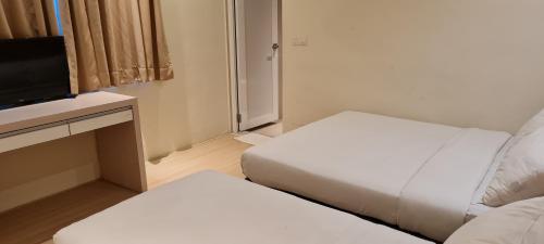a small room with two beds and a television at Star Tree Homestay -Contactless Self Check in in Kuantan