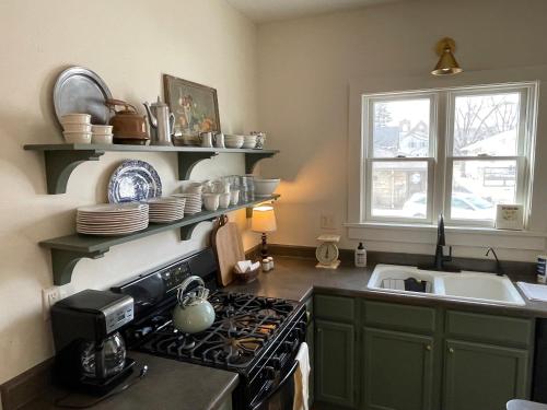 a kitchen with a stove top oven next to a sink at Old Town Inn in Sioux Center