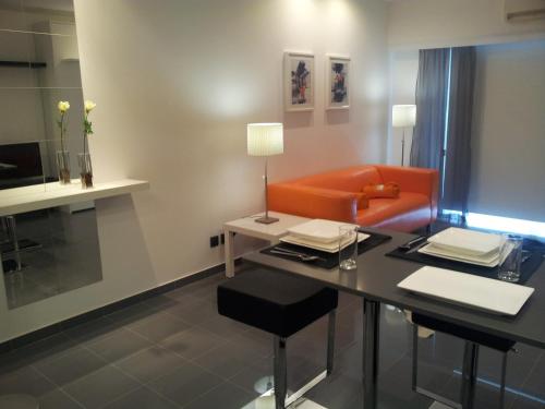 a living room with a table and a couch at Apartamento Rocamar - Albufeira in Albufeira