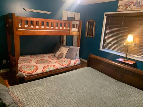 a bedroom with two bunk beds and a window at Family Friendly Downtown Home - Private Yard & Grill - Location, Location, Location! in Athens