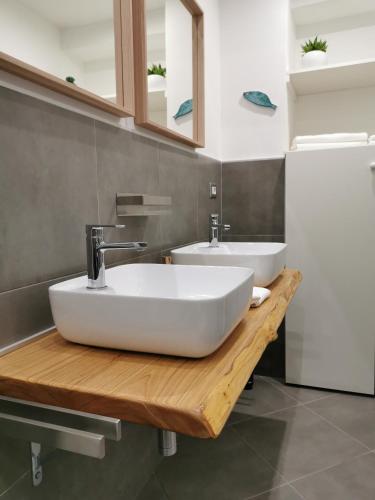 a bathroom with two sinks on a wooden counter at Octopus Vietri House in Vietri sul Mare