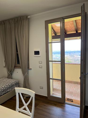 a bedroom with a bed and a sliding glass door at CASA AL VENTO in Cerreto Guidi