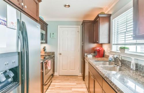 a kitchen with a sink and a refrigerator at Island Getaway in Galveston