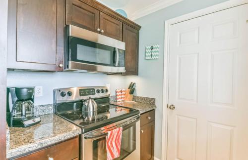 a kitchen with a stove and a microwave at Island Getaway in Galveston