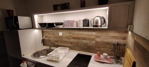 a small kitchen with a sink and a microwave at Apartment New Days in Sarajevo
