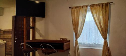 a room with a window with a dresser and a mirror at Apartment New Days in Sarajevo