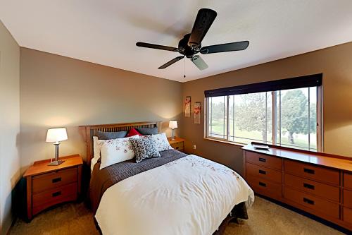 a bedroom with a bed with a ceiling fan at Eagle Crest in Redmond